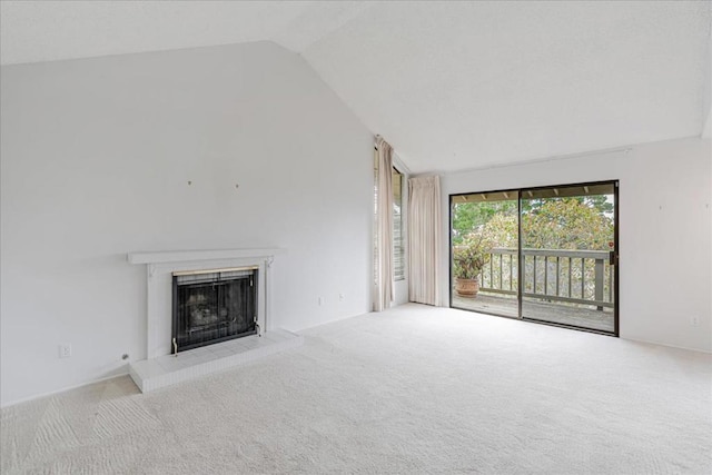 unfurnished living room featuring light colored carpet, a tiled fireplace, and vaulted ceiling