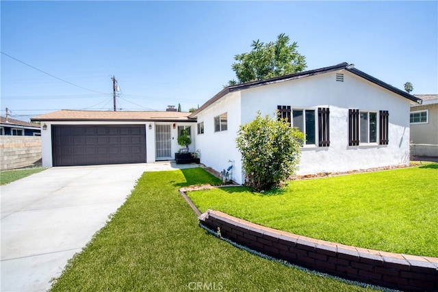 ranch-style house featuring a front yard and a garage