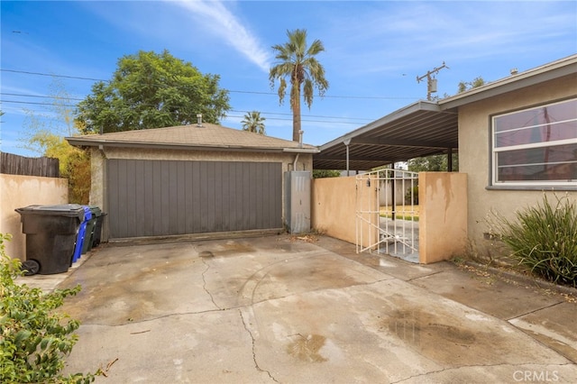 view of patio / terrace featuring an outbuilding and a garage