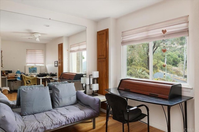 sitting room with hardwood / wood-style flooring, ceiling fan, and a wealth of natural light