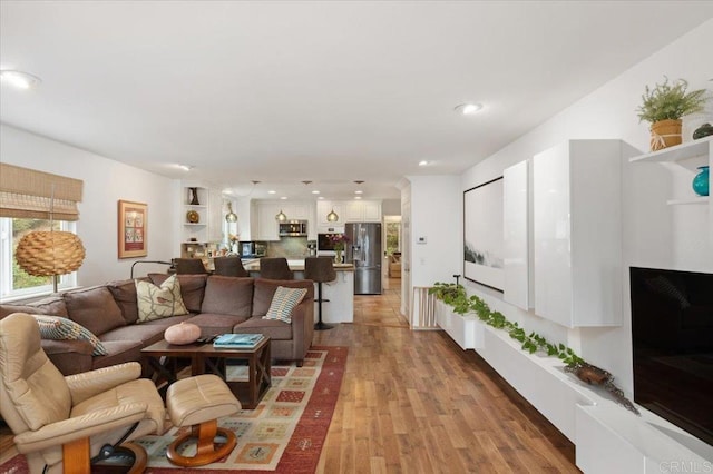 living room with light hardwood / wood-style flooring