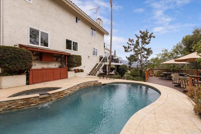 view of swimming pool featuring an in ground hot tub and a patio area