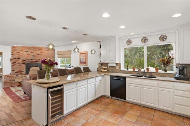 kitchen featuring kitchen peninsula, white cabinets, decorative light fixtures, dishwasher, and wine cooler