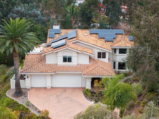 mediterranean / spanish house featuring a garage