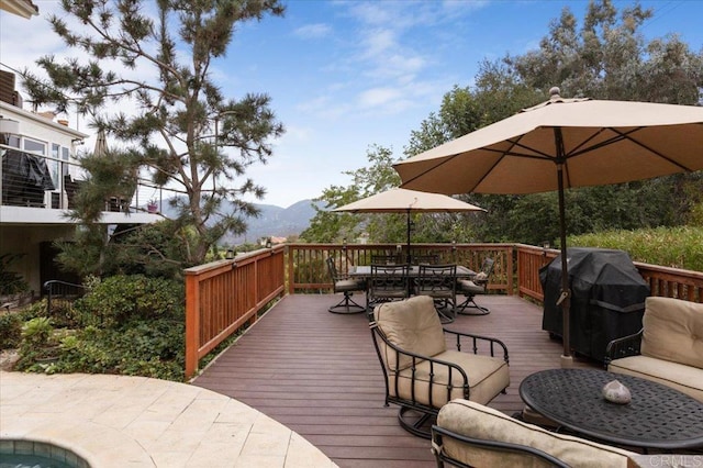 wooden terrace featuring grilling area and a mountain view