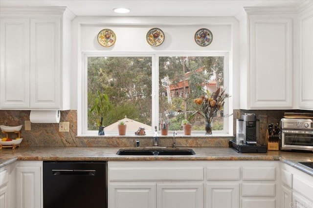 kitchen with white cabinets, decorative backsplash, black dishwasher, and sink