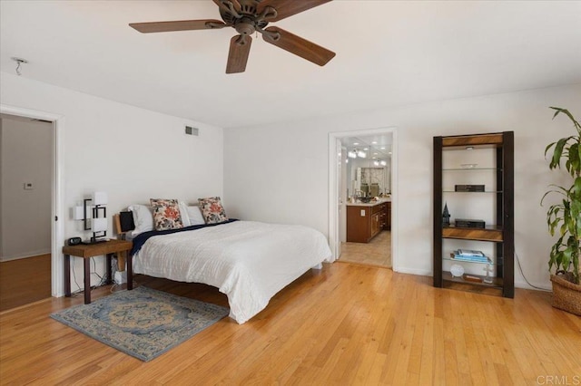 bedroom featuring ensuite bath, ceiling fan, and light hardwood / wood-style floors