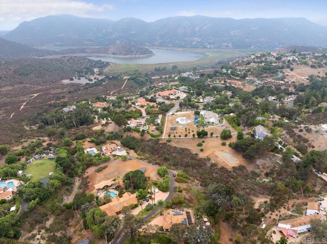 drone / aerial view featuring a water and mountain view