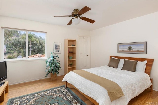 bedroom with ceiling fan and light hardwood / wood-style flooring