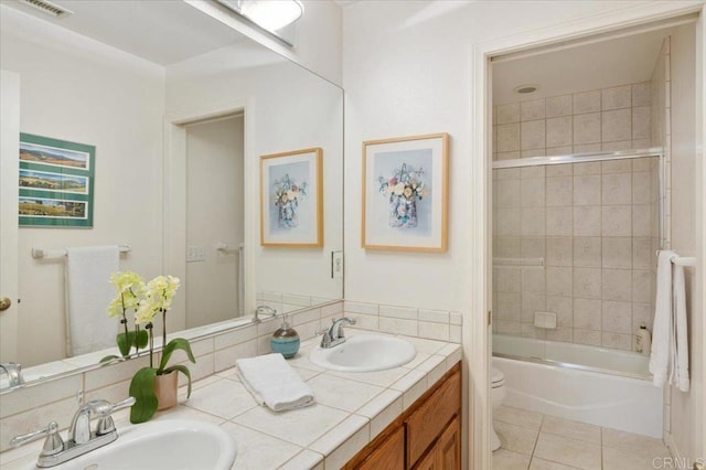 full bathroom featuring tile patterned flooring, vanity, toilet, and enclosed tub / shower combo