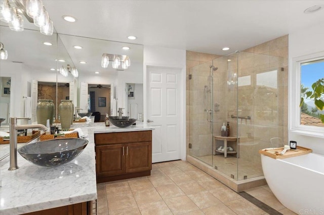 bathroom featuring tile patterned floors, ceiling fan, vanity, and independent shower and bath