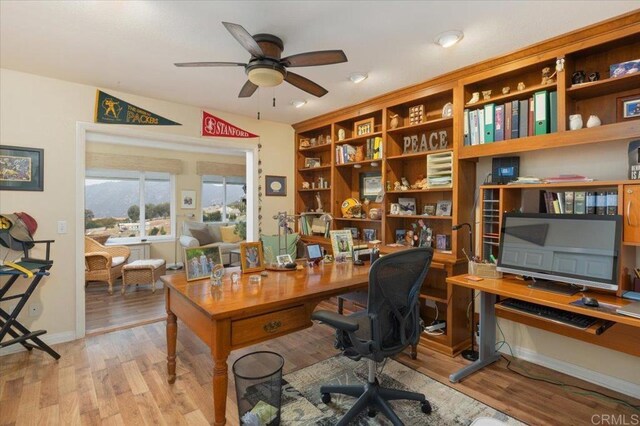 office area with ceiling fan and light hardwood / wood-style flooring