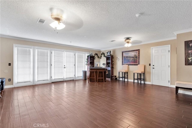 living room featuring a textured ceiling, ceiling fan, and ornamental molding