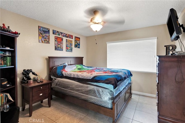 tiled bedroom with a textured ceiling and ceiling fan