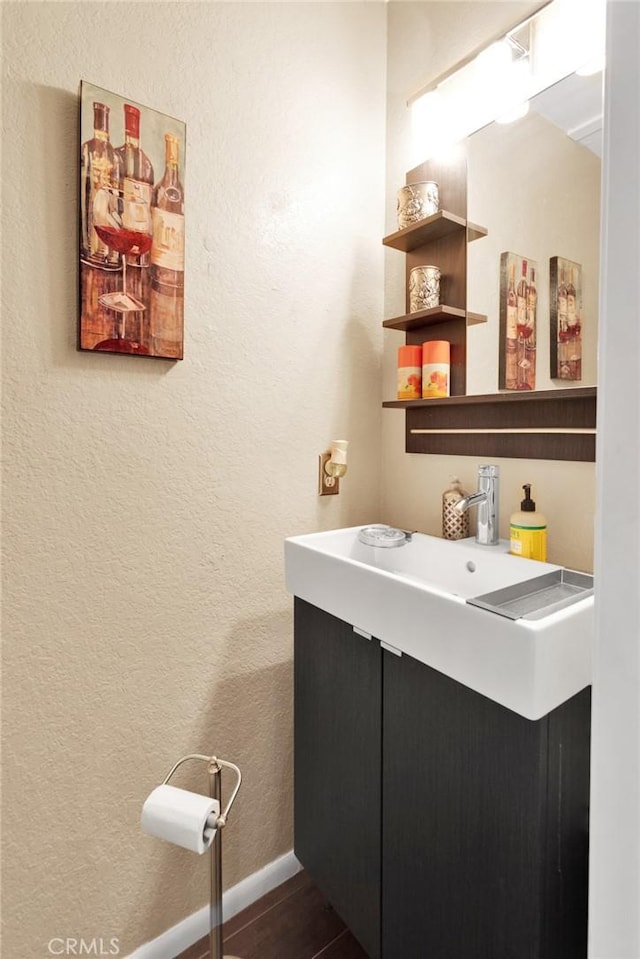 bathroom with hardwood / wood-style flooring and vanity