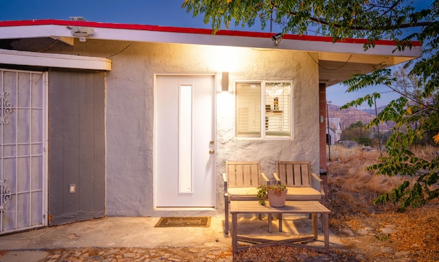 entrance to property with a patio