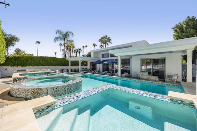 view of pool with a patio area and an in ground hot tub