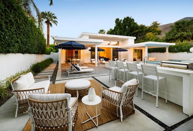 view of patio / terrace with an outdoor living space and a bar