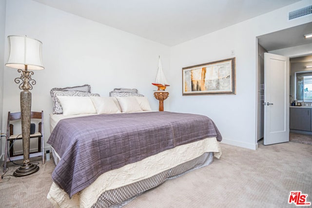 carpeted bedroom with connected bathroom