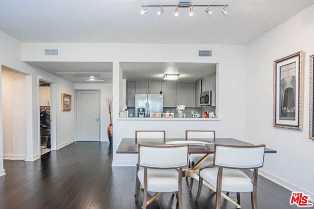 dining area featuring dark hardwood / wood-style flooring