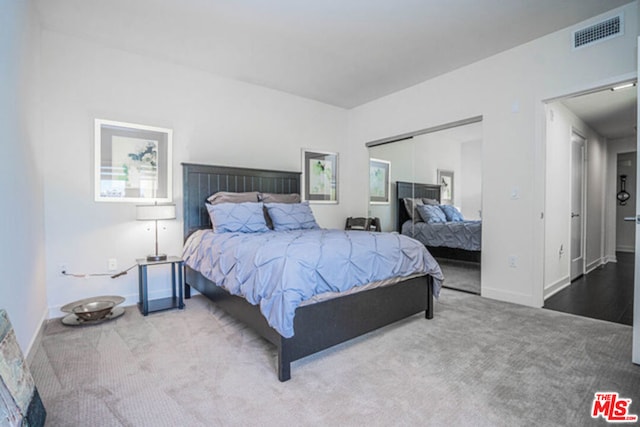 bedroom featuring light wood-type flooring and a closet