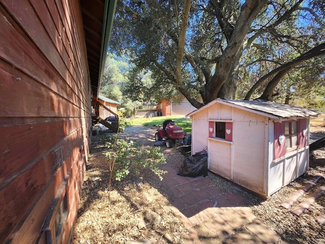 view of side of property with a shed