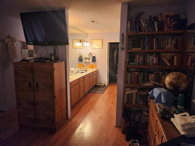 hallway featuring a textured ceiling and light wood-type flooring