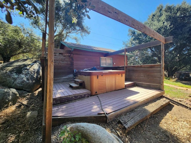 wooden terrace with a hot tub