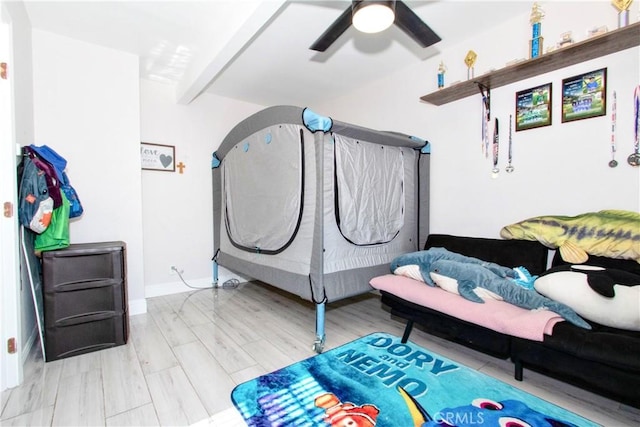 bedroom with beam ceiling, light wood-type flooring, and ceiling fan