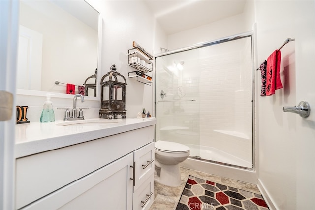 bathroom with toilet, an enclosed shower, and vanity