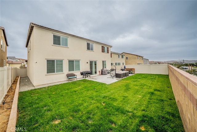 rear view of property featuring a patio area, outdoor lounge area, and a yard