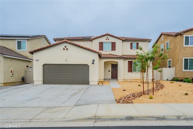 mediterranean / spanish house with a garage