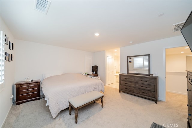 carpeted bedroom featuring ensuite bathroom