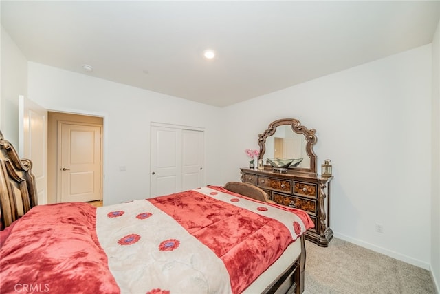 bedroom with a closet and light carpet