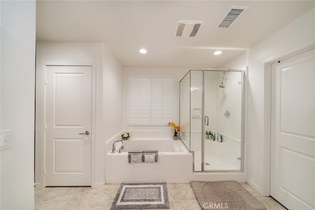 bathroom featuring tile patterned flooring and separate shower and tub