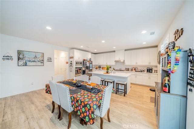 dining area with light wood-type flooring