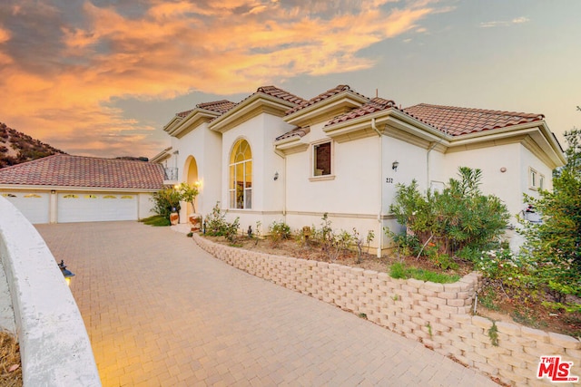 mediterranean / spanish-style home featuring a garage