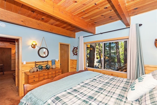 carpeted bedroom with wood ceiling, beam ceiling, and wooden walls