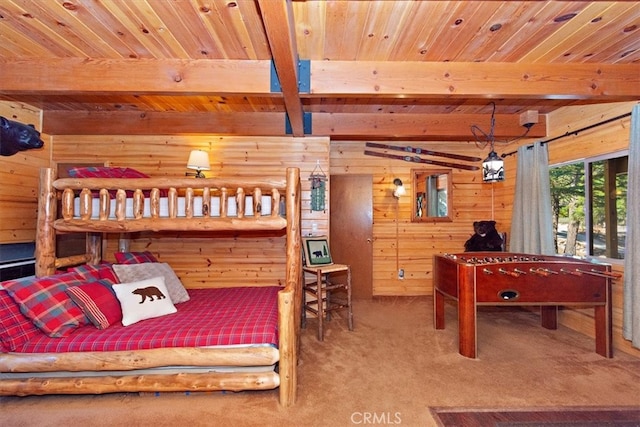 bedroom featuring wood walls, beam ceiling, wooden ceiling, and carpet floors