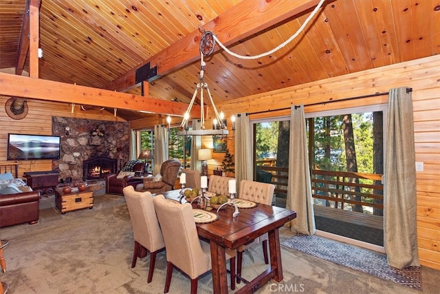 dining space featuring a stone fireplace, carpet flooring, a healthy amount of sunlight, and wooden ceiling