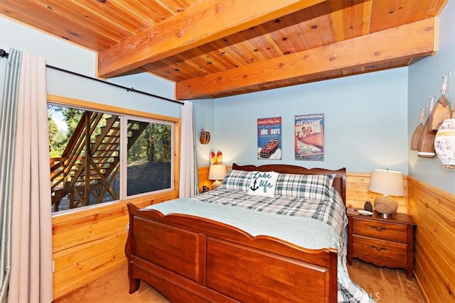 bedroom featuring beam ceiling, wood walls, wood ceiling, and light colored carpet