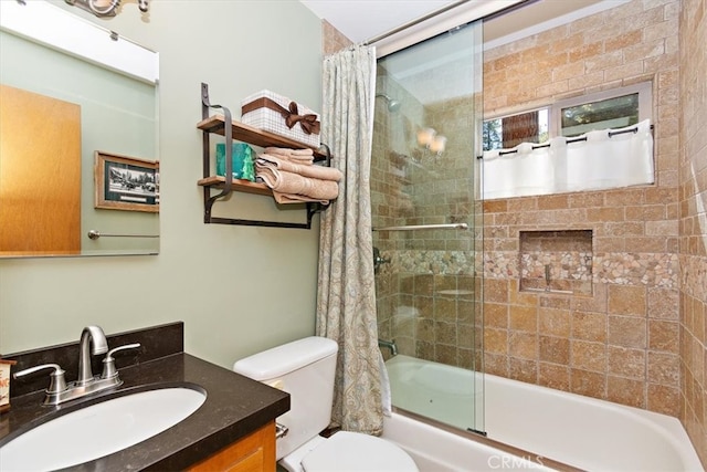 full bathroom with vanity, shower / tub combo with curtain, and toilet