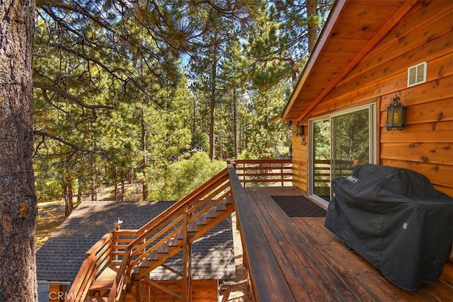 wooden terrace with a grill