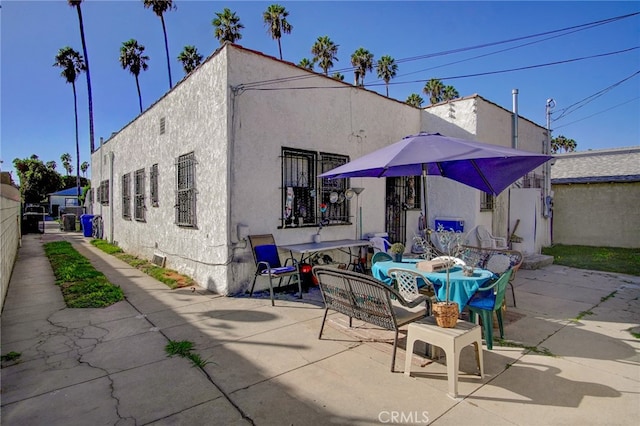 rear view of house featuring a patio and an outdoor hangout area