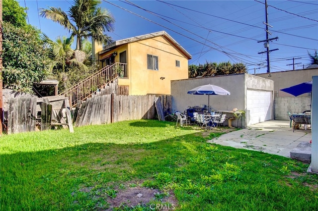 view of yard with a patio area and a garage