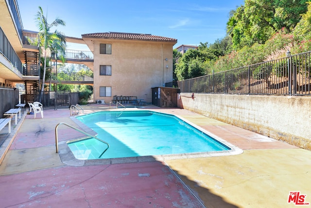 view of swimming pool with a patio