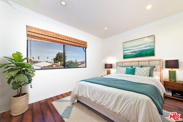 bedroom with dark hardwood / wood-style flooring and crown molding