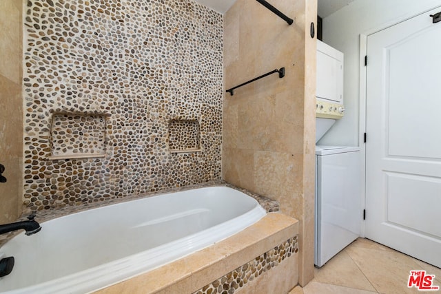 bathroom with stacked washer and clothes dryer and tile patterned flooring