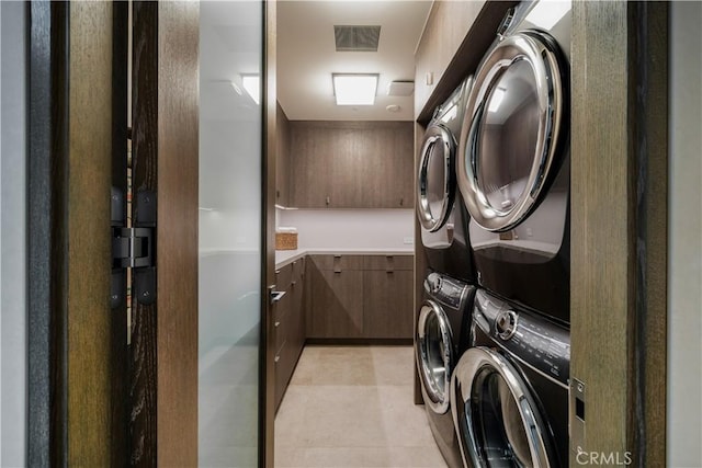 clothes washing area featuring stacked washer and dryer