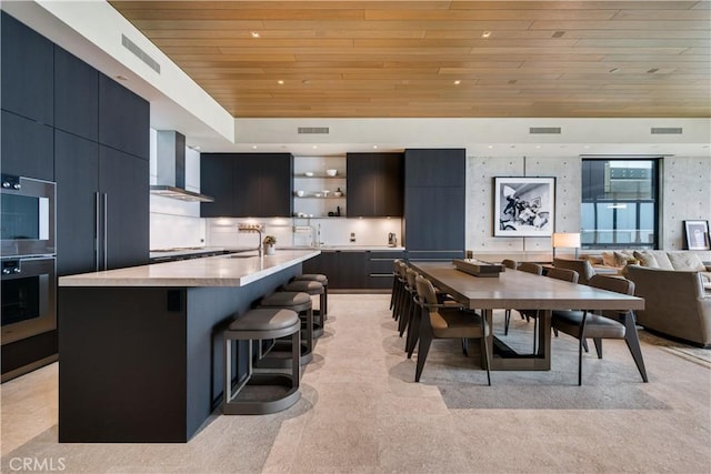 dining space featuring sink and wood ceiling